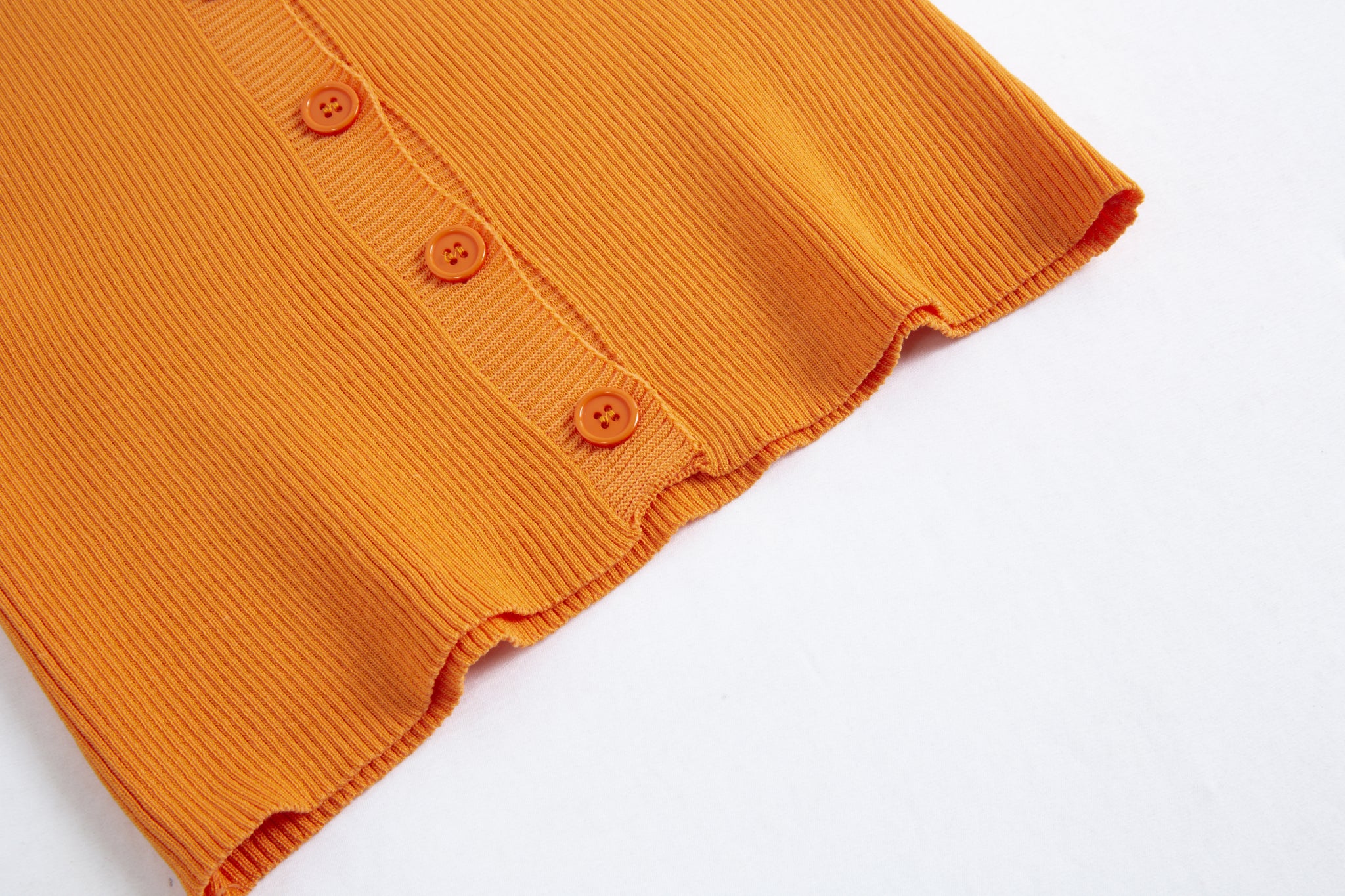 Merra Muse halter V-neck ribbed button tank with a fitted silhouette 
